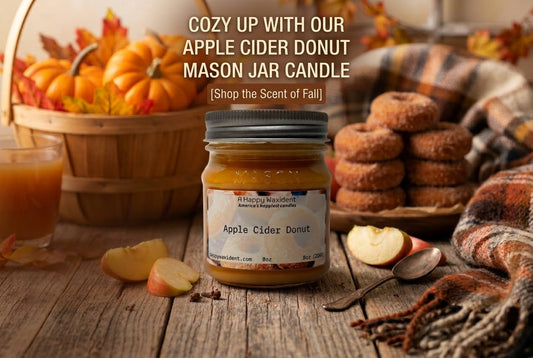An autumn-themed still life with an Apple Cider Donut mason jar candle, pumpkins, and donuts.
