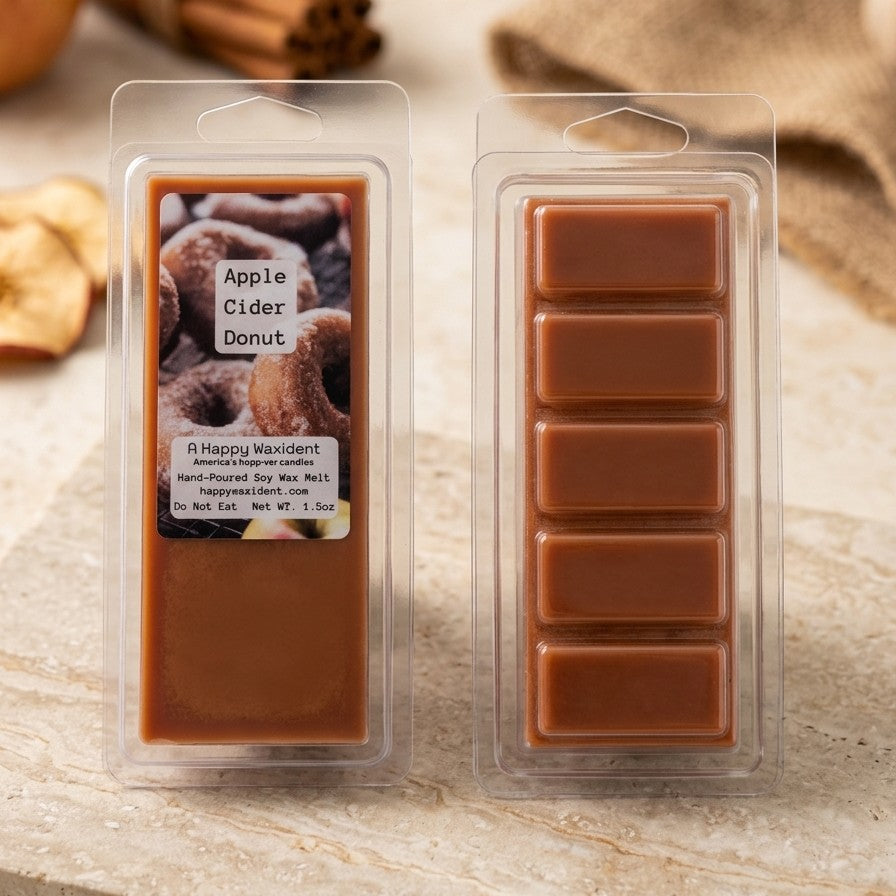 Packaged Apple Cider Donut wax melts on a wooden surface with cinnamon sticks and burlap in the background.